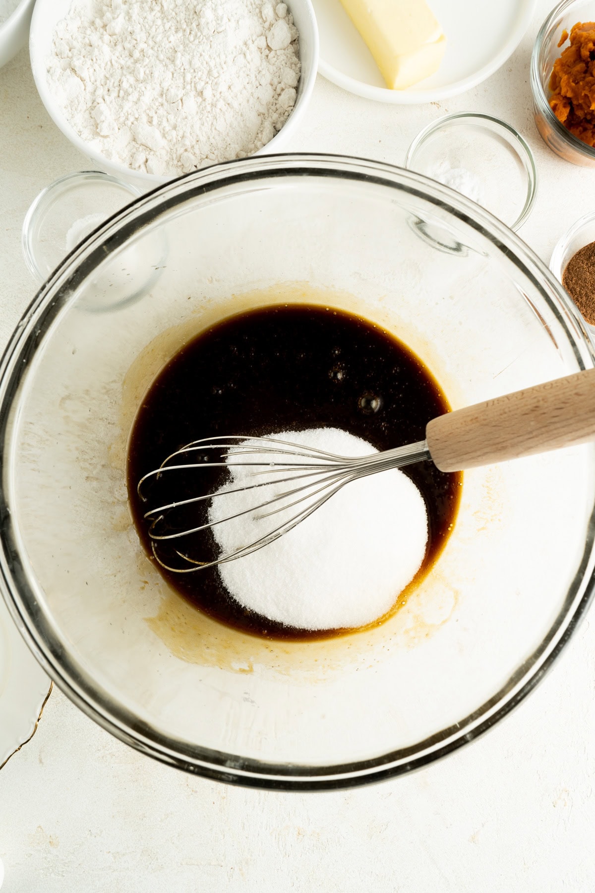 Sugar added to a mixing bowl for cookies.