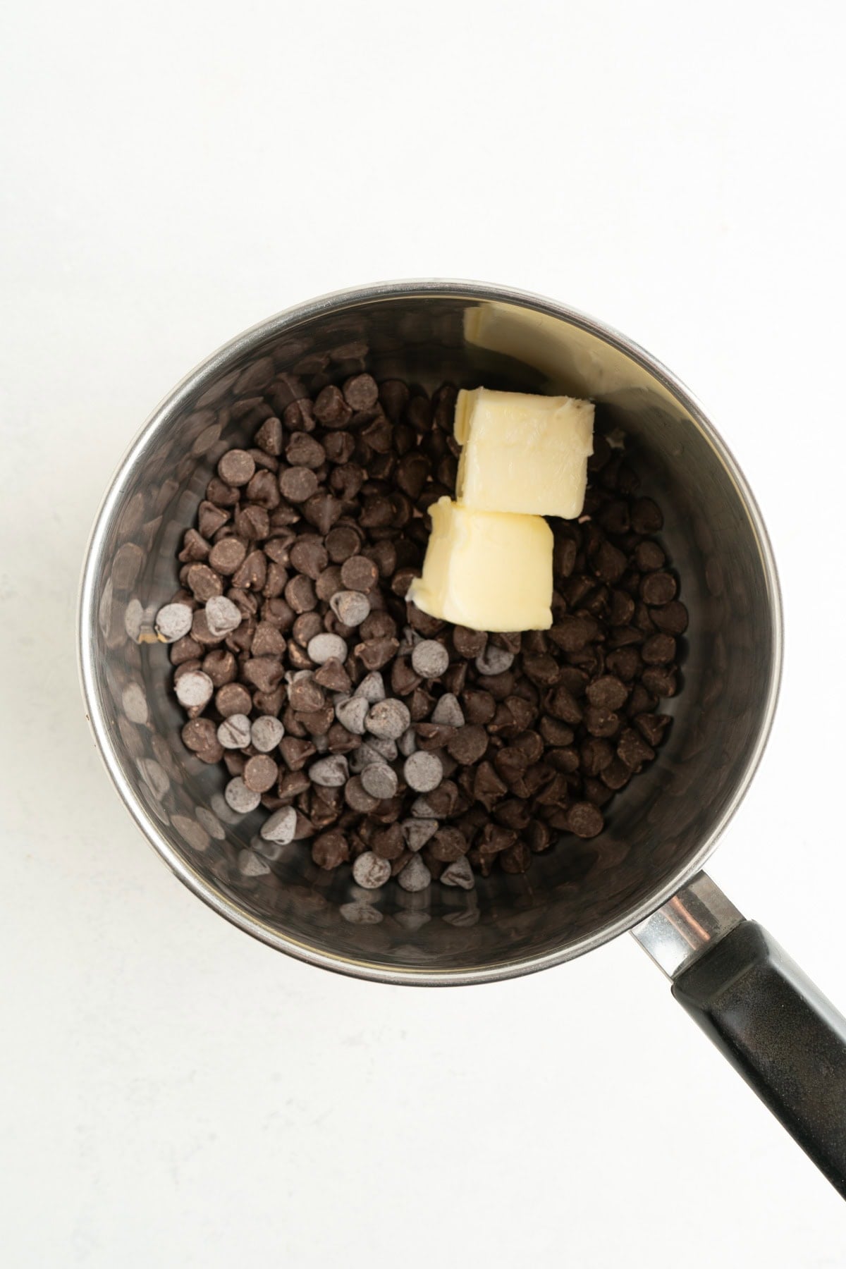 A pot of chocolate chips and butter ready to be melted.