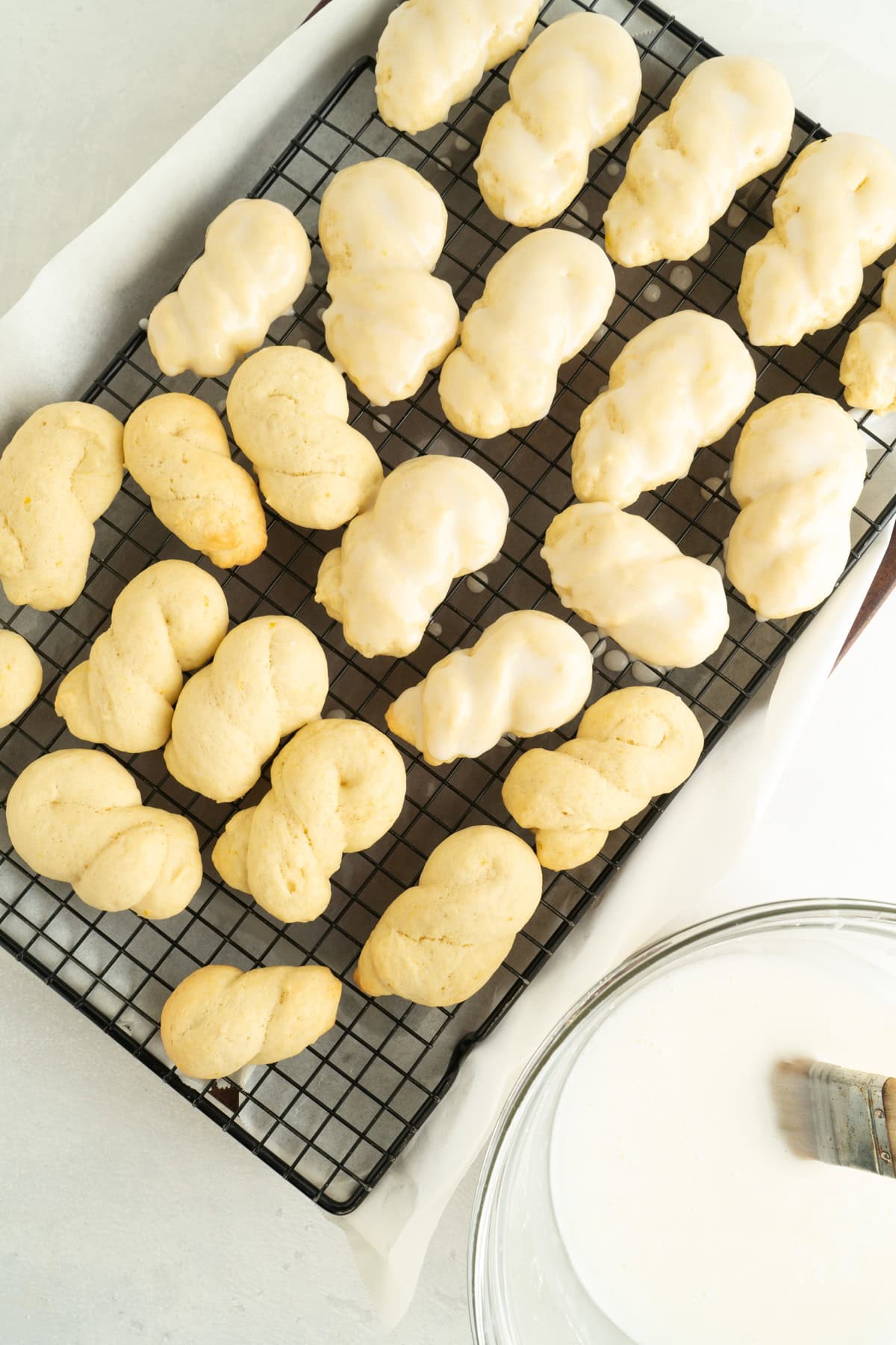 Italian knot cookies being iced.