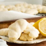An Italian knot cookie on a plate with lemons.