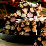 A stack of chocolate and marshmallow squares on a plate.