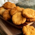 A pile of johnny cakes on a cutting board.