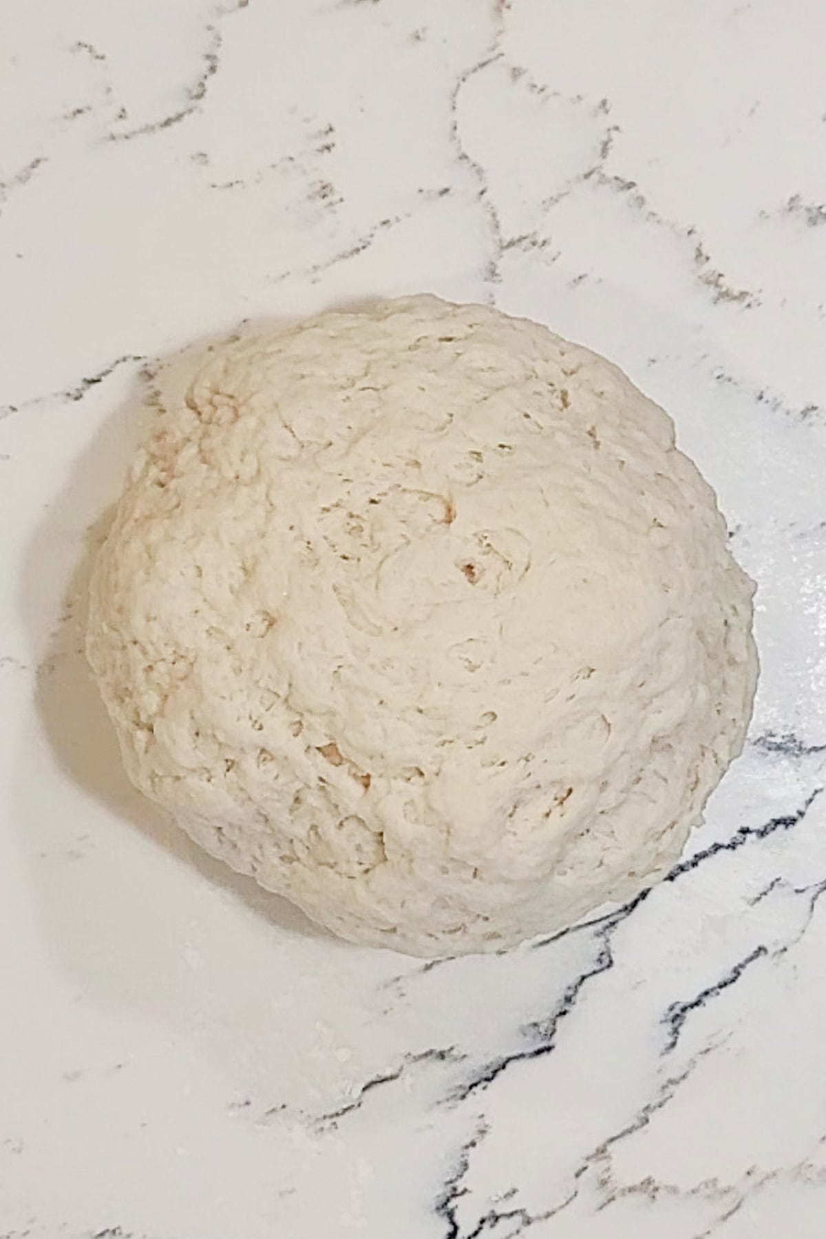 A ball of dough on a counter.
