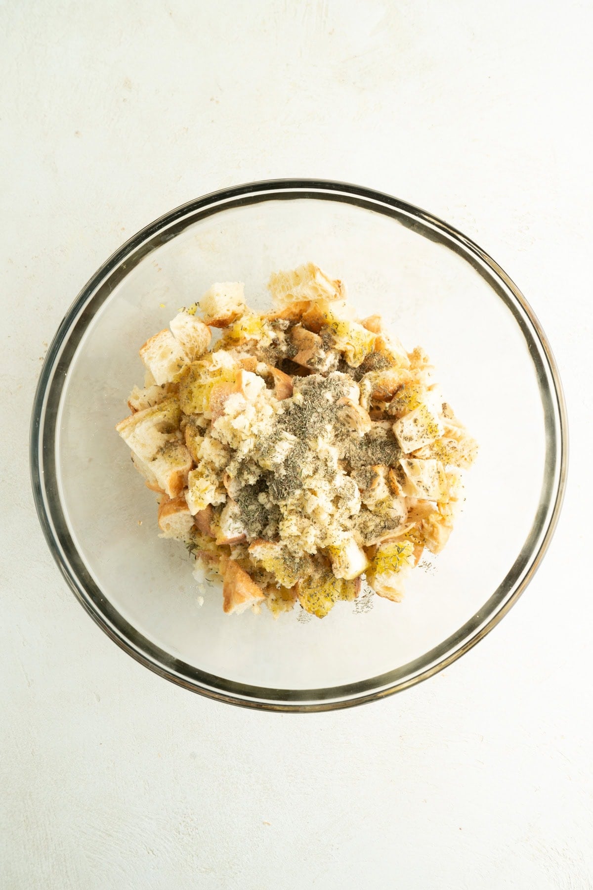A bowl of cubed stale croutons and seasonings.