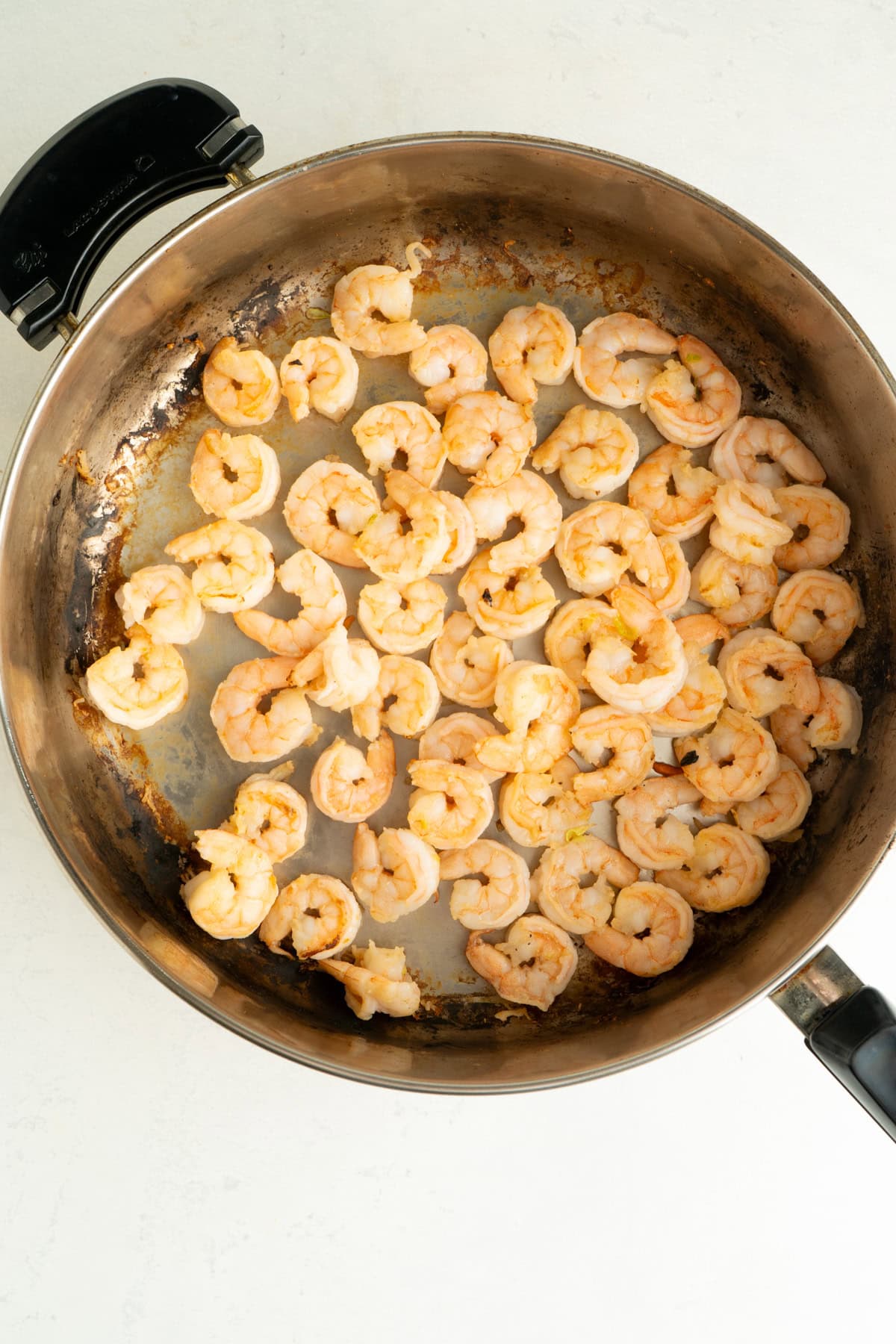 A large pan with sauteed shrimp.