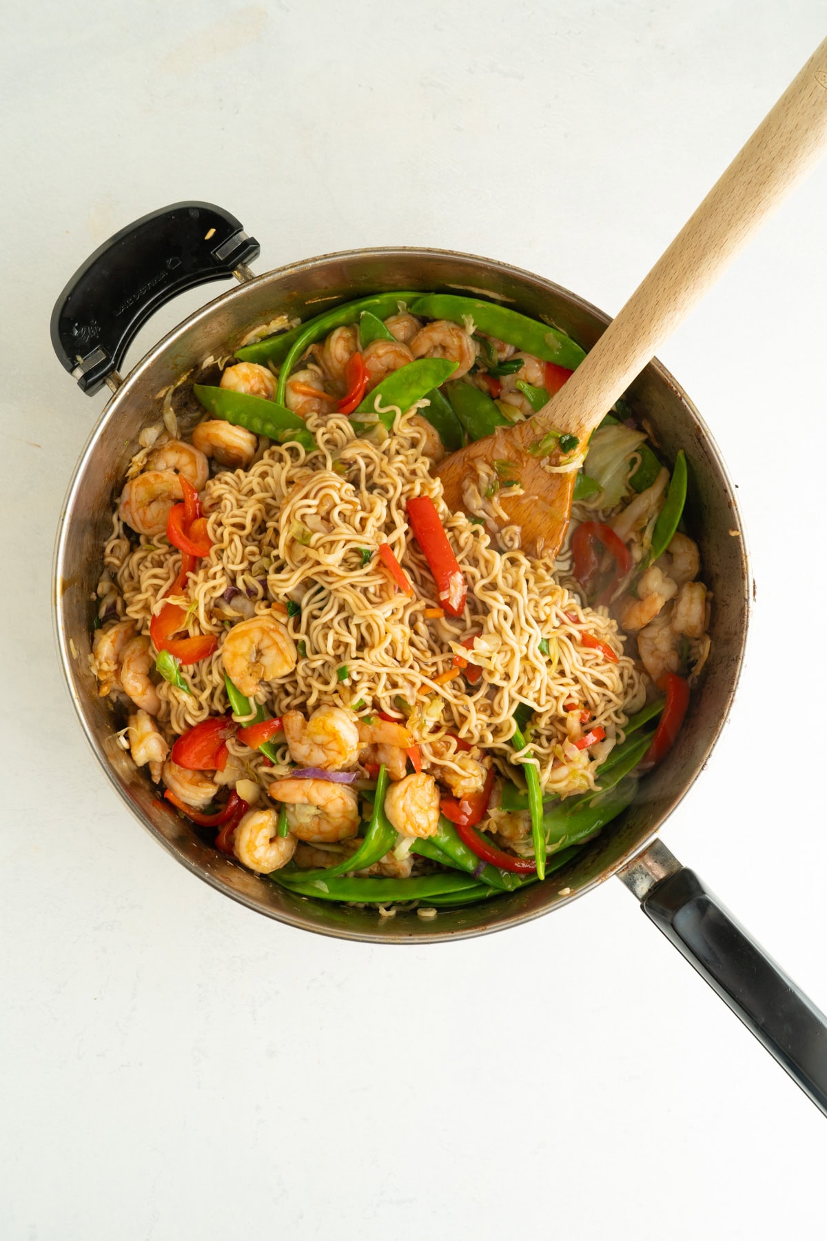 A shrimp fry in a large pan with noodles.