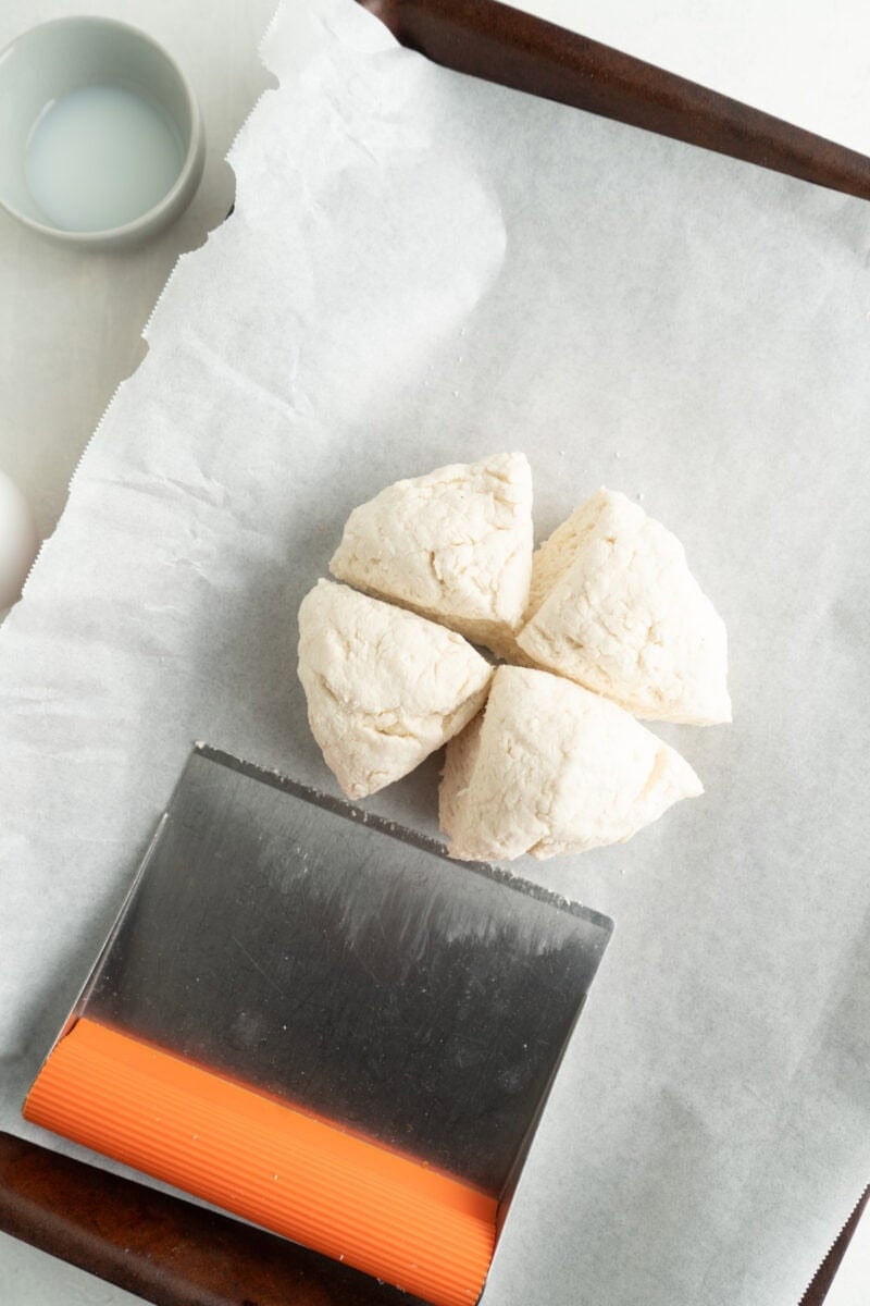 Bagel dough cut into quarters.