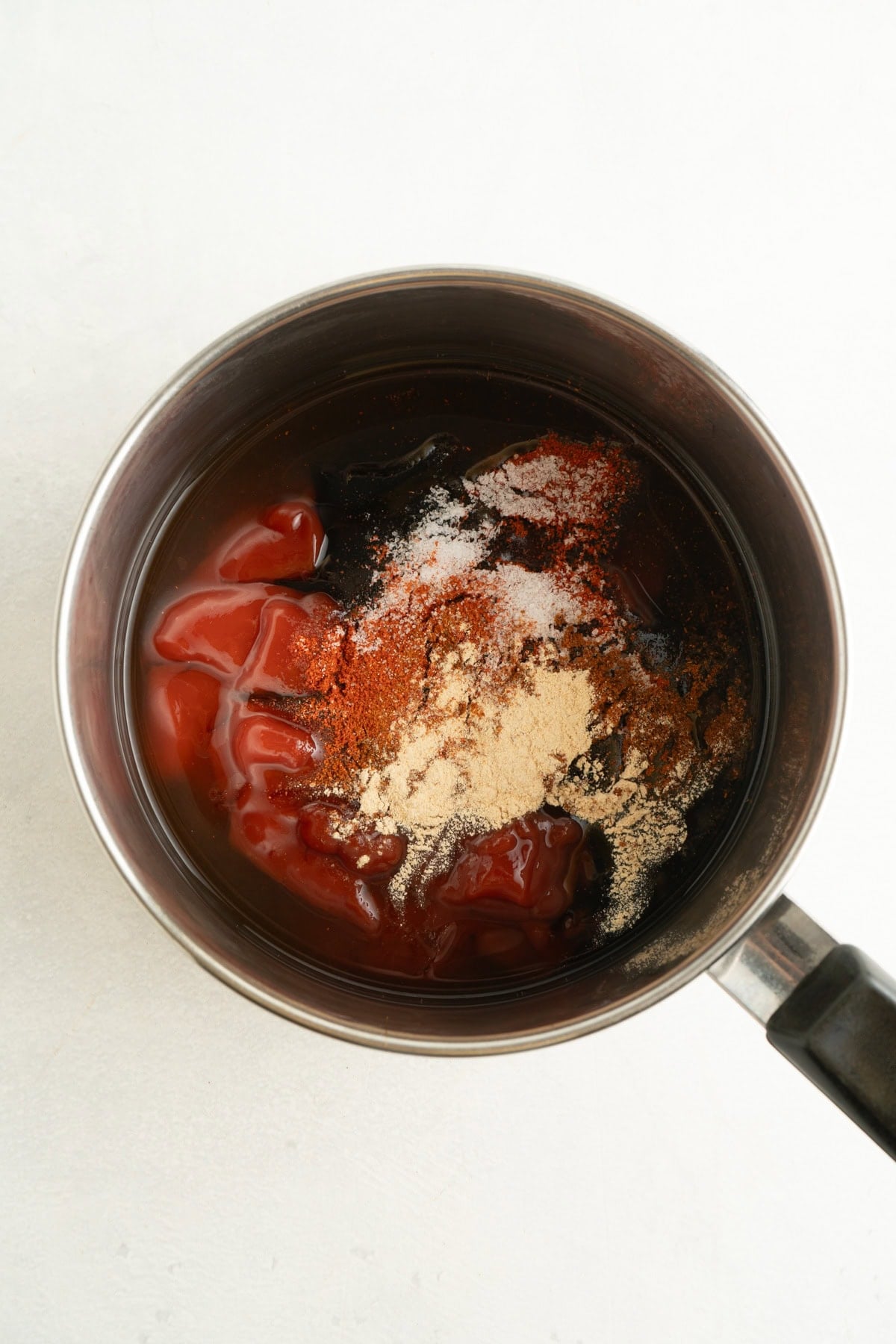 A saucepan with the ingredients for a barbecue sauce.