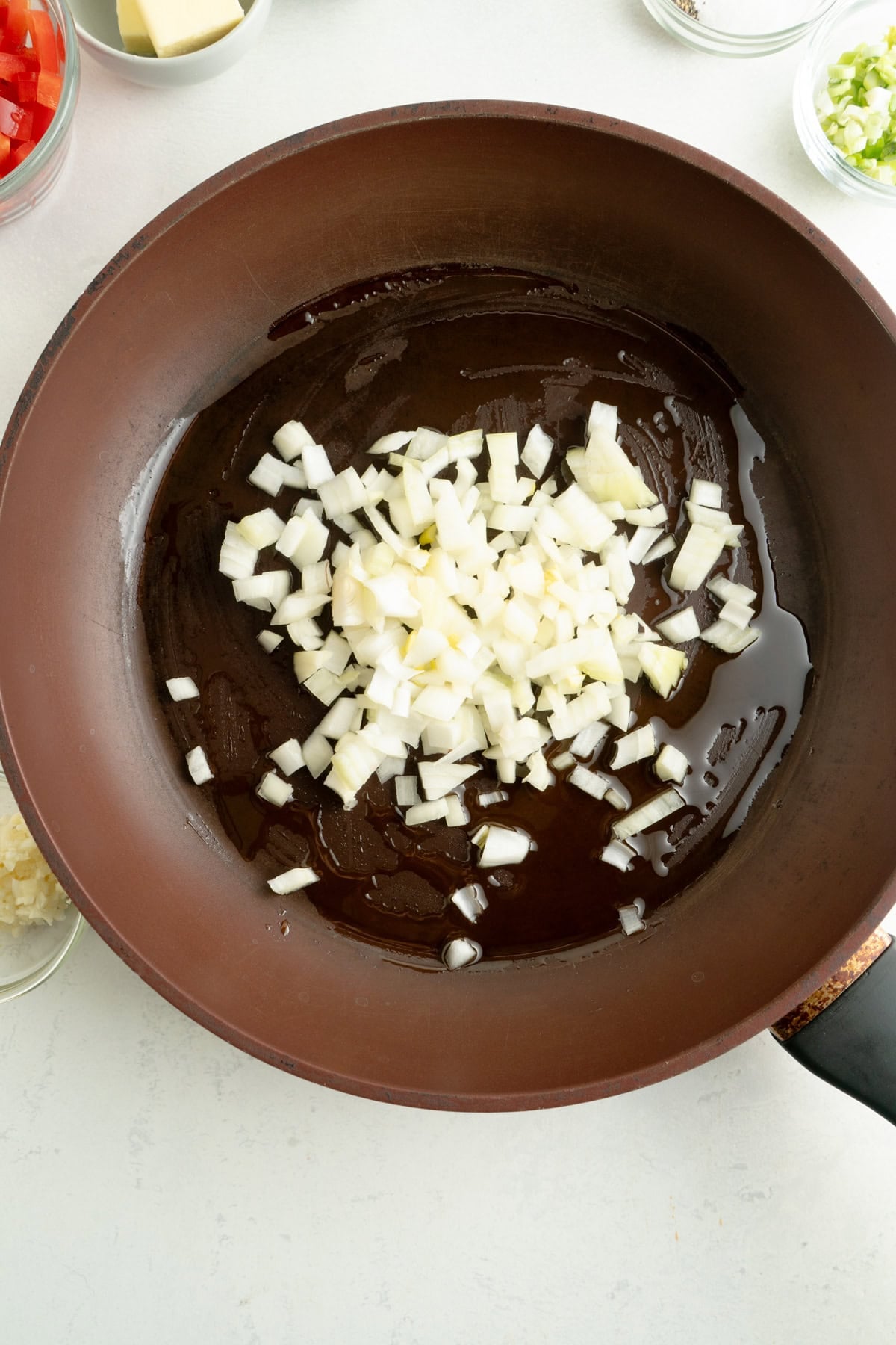 Onions and olive oil in a pan.