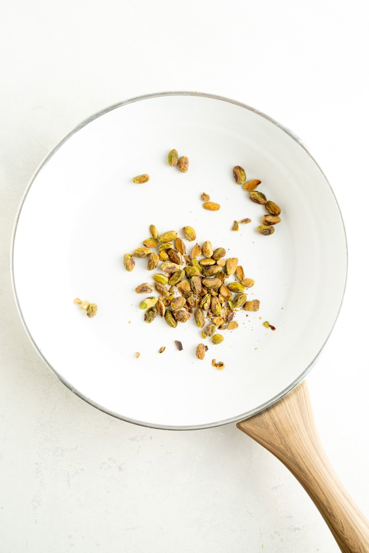 Pistachios in a white pan.