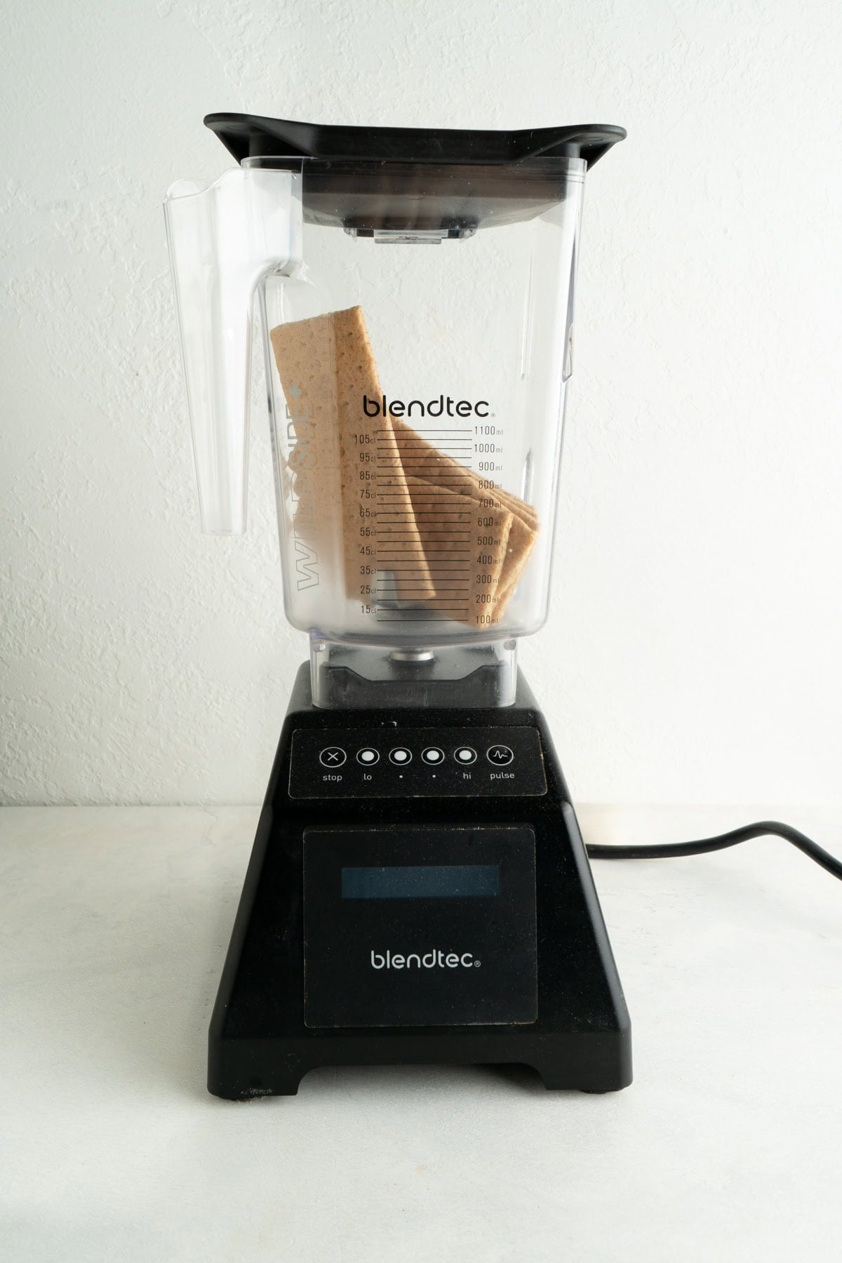 A blender with graham crackers inside.