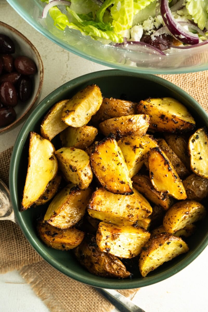 A bowl of baked lemon Greek Potatoes.