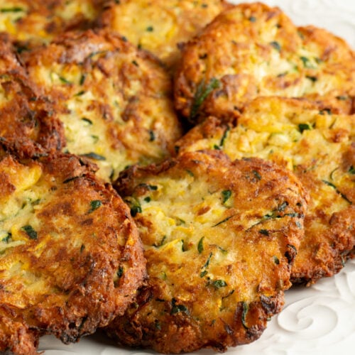 Close up of Italian Zucchini Fritters on a white plate.