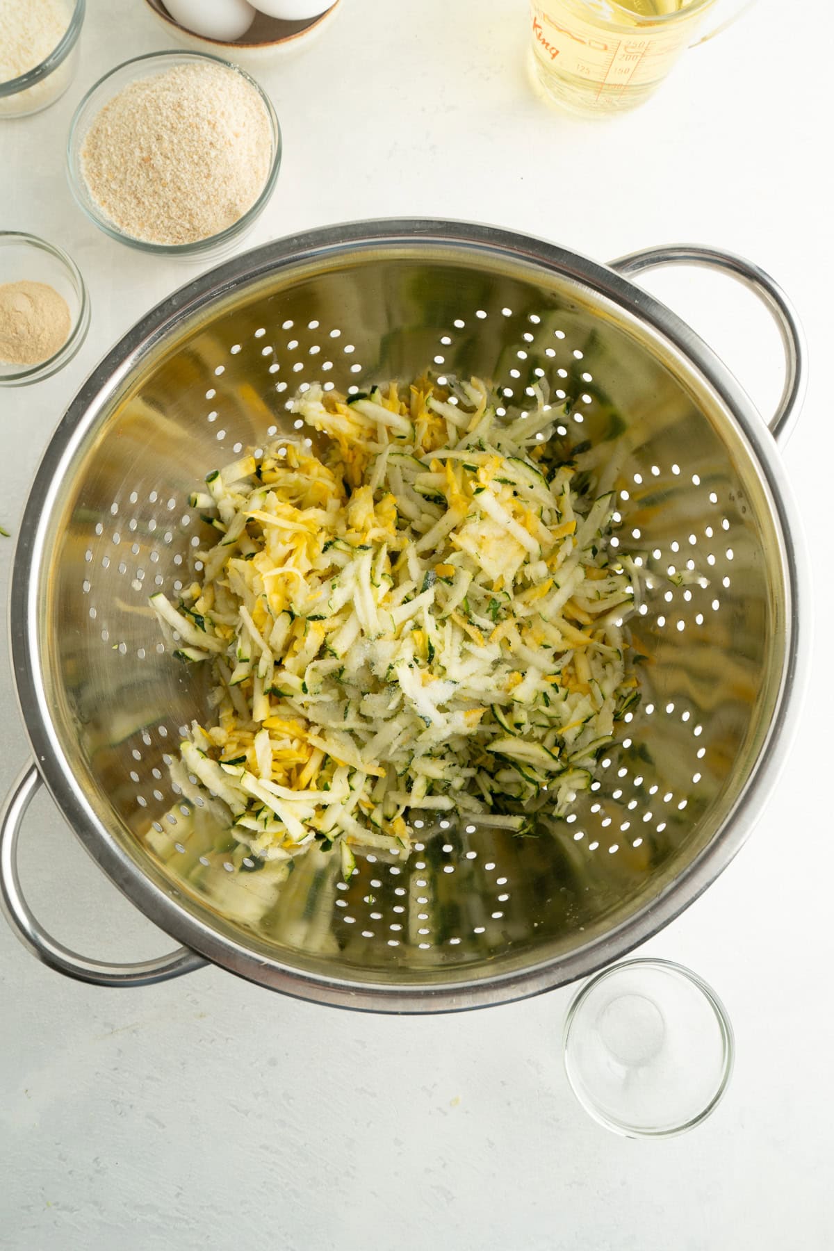 A colander or grated zucchini and salt.