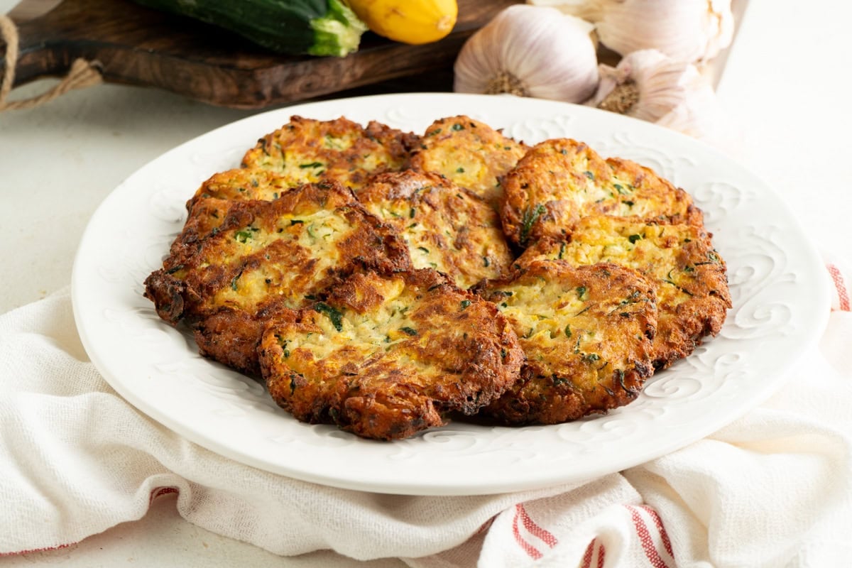 A plate of Italian zucchini fritters on a table.