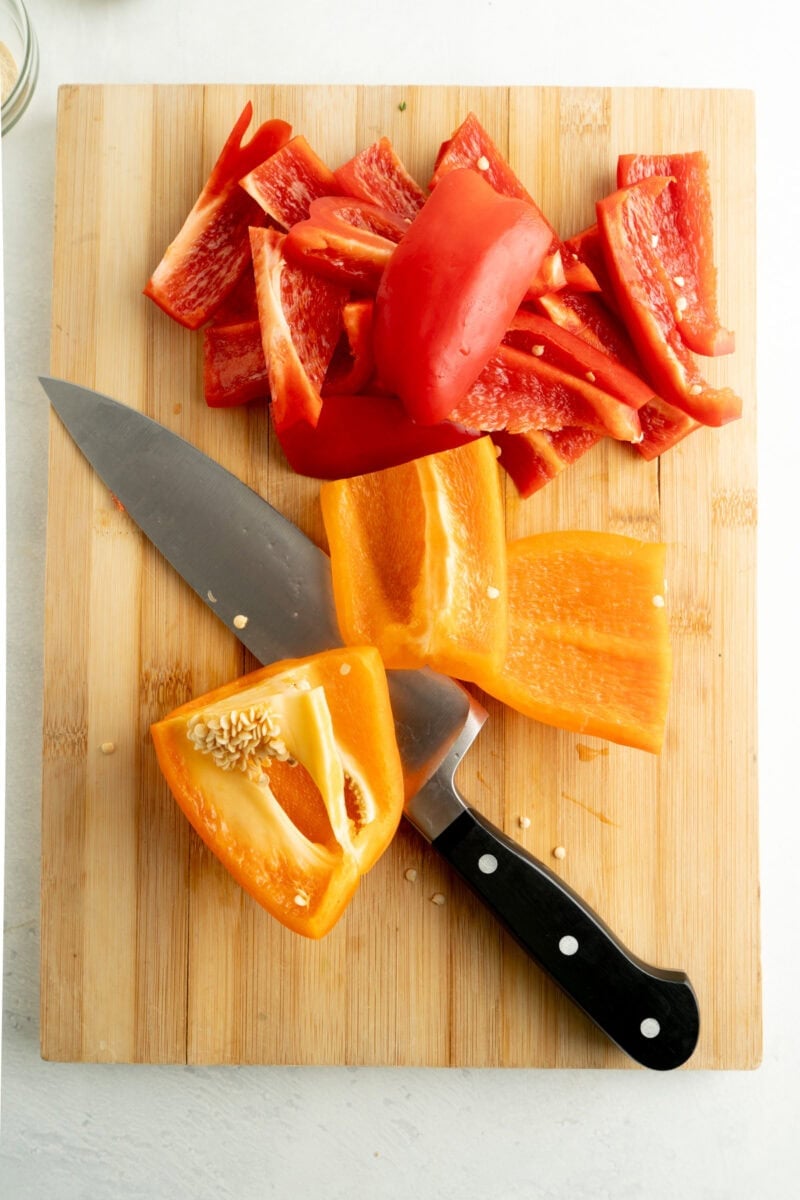Peppers being chopped into large slices.