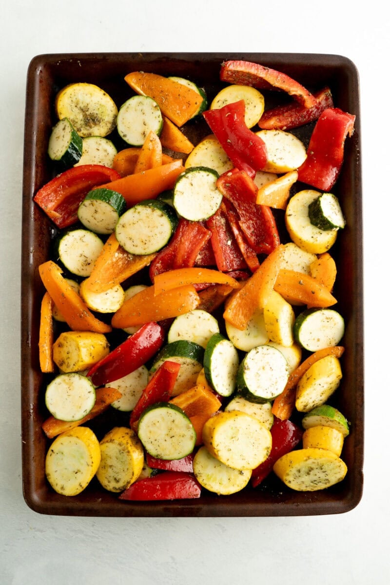 A baking sheet filled with a mix of veggies for roasting.