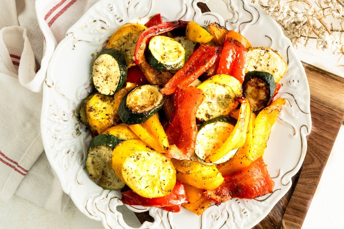Overhead shot of a plate filled with a roasted zucchini and pepper recipe.