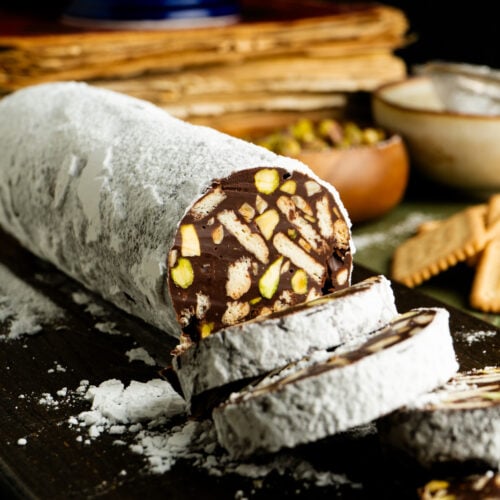 A sliced chocolate salami on a table.