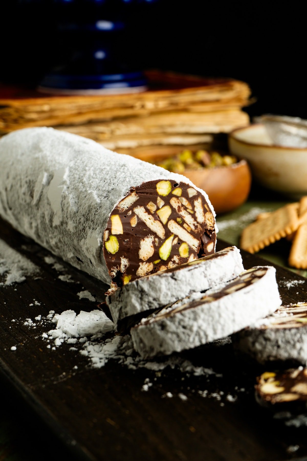 A sliced chocolate salami on a table.