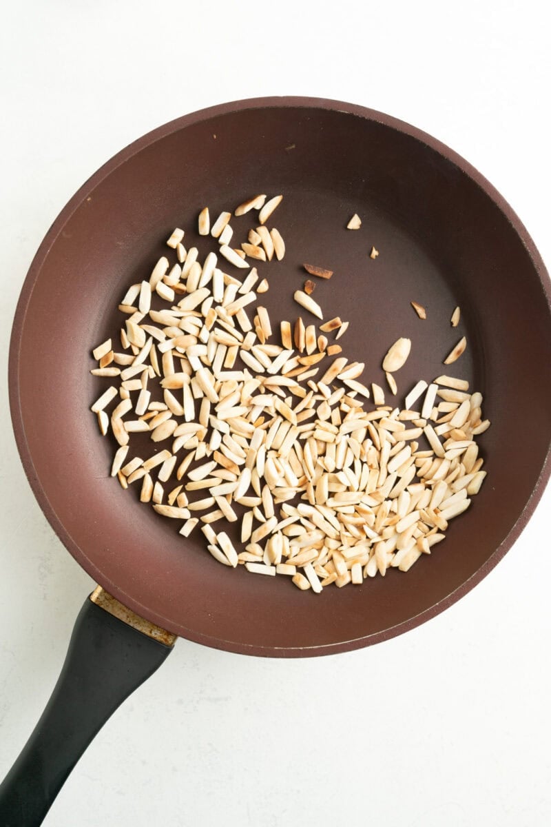 Toasted slivered almonds in a pan.