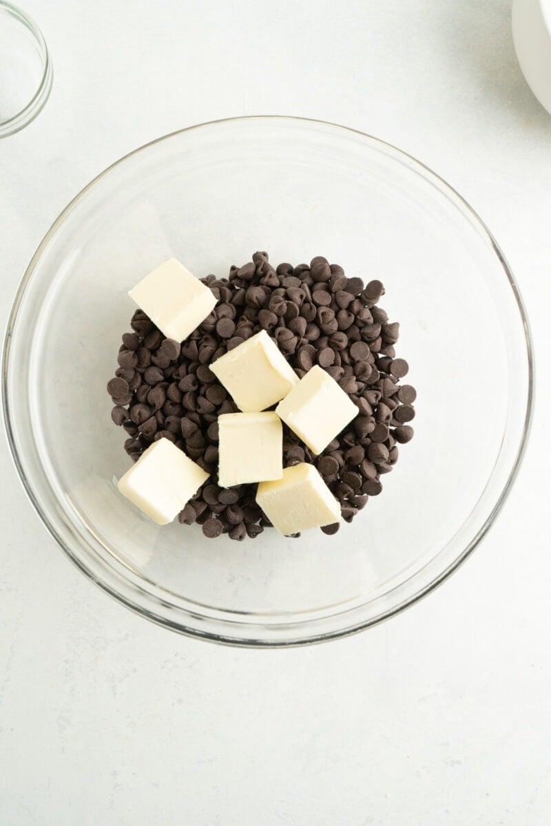 Chocolate chips and butter in a bowl.