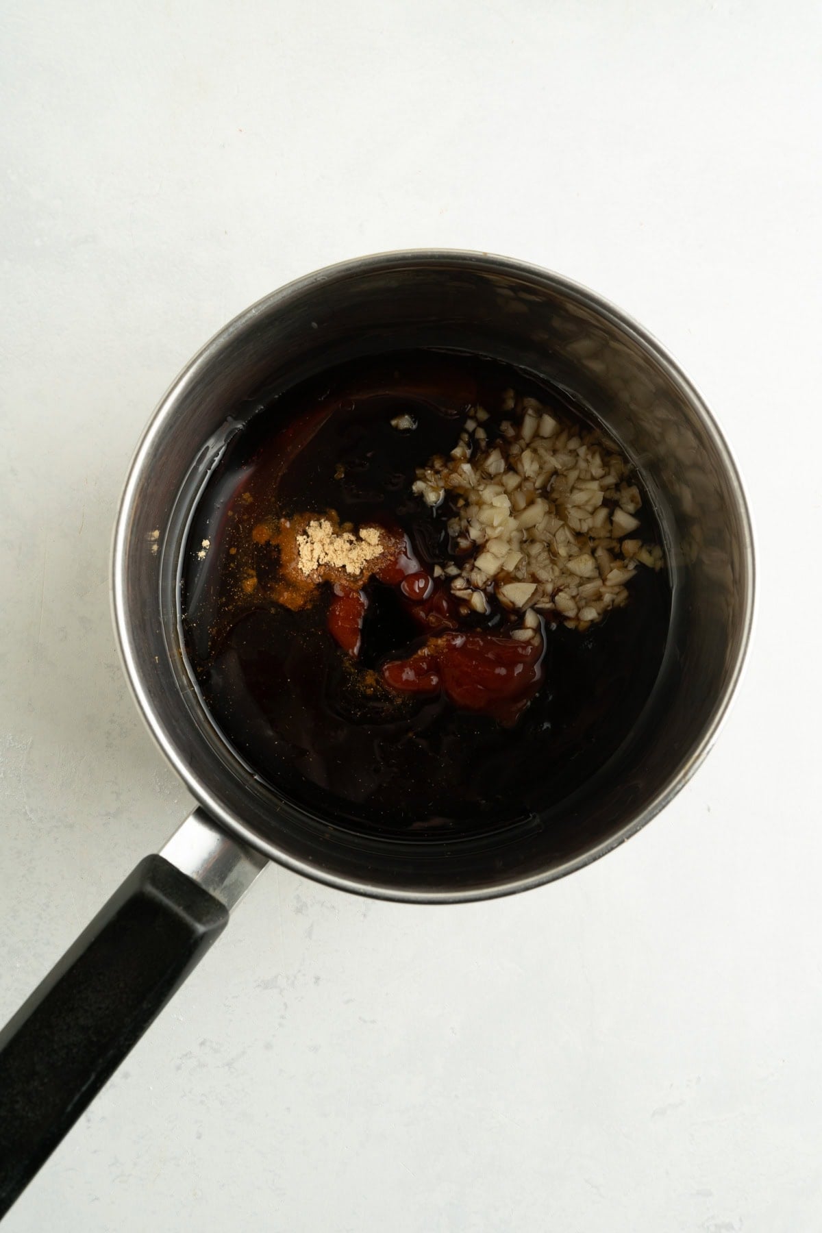 Asian bbq sauce ingredients in a small pot.