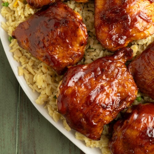 An overhead shot of a platter of BBQ Air Fryer Chicken Thighs with rice.