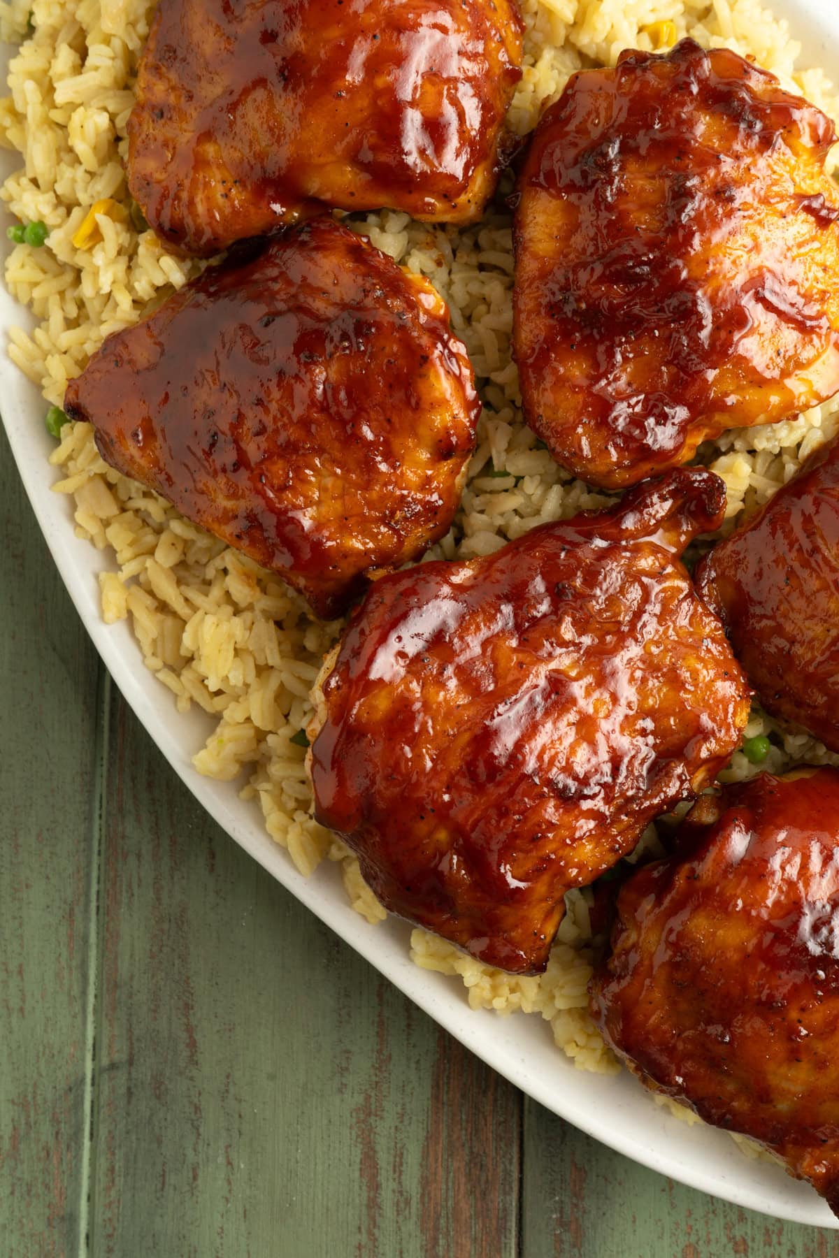 An overhead shot of a platter of BBQ Air Fryer Chicken Thighs with rice.