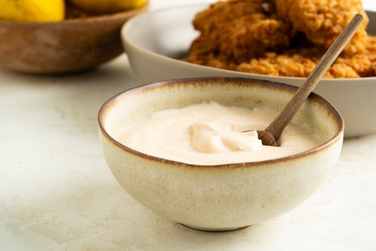 A bowl of Peri Peri Dip made with Greek Yogurt on a table.