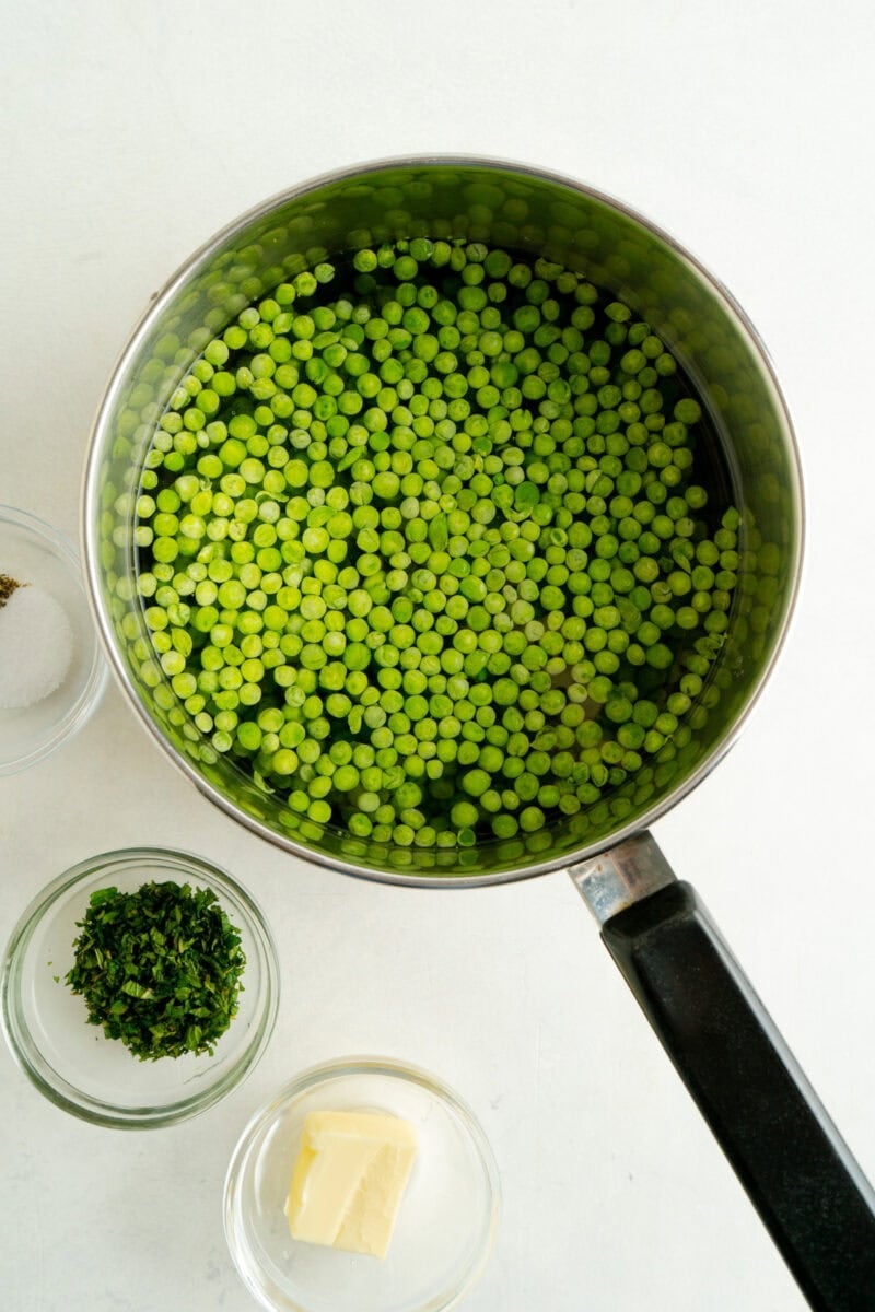 A pot of frozen peas and water.