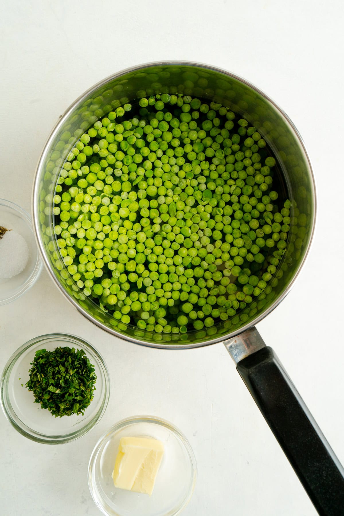 A pot of frozen peas and water.