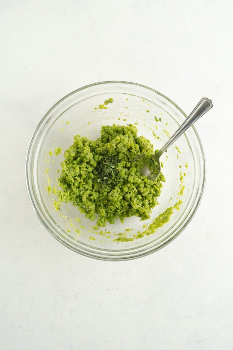 Peas mushed up in a bowl.