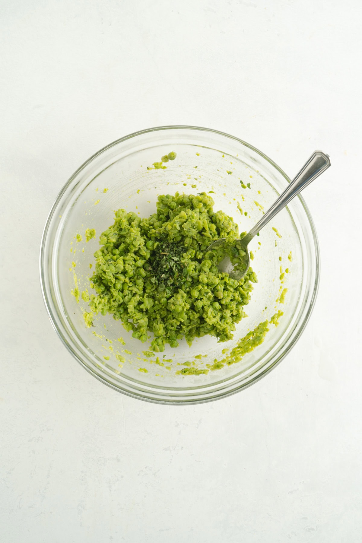 Peas mushed up in a bowl.