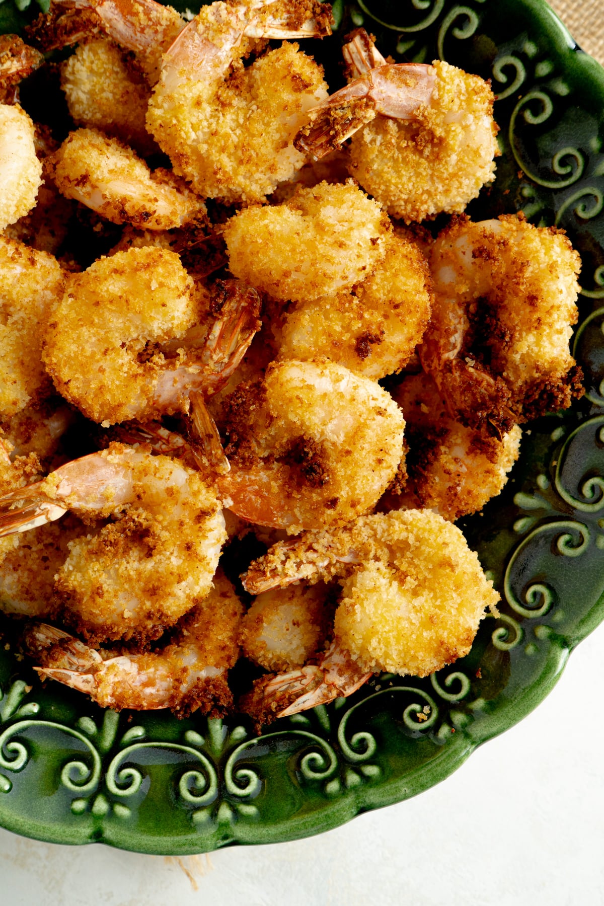 Close up of panko shrimp in a green bowl.