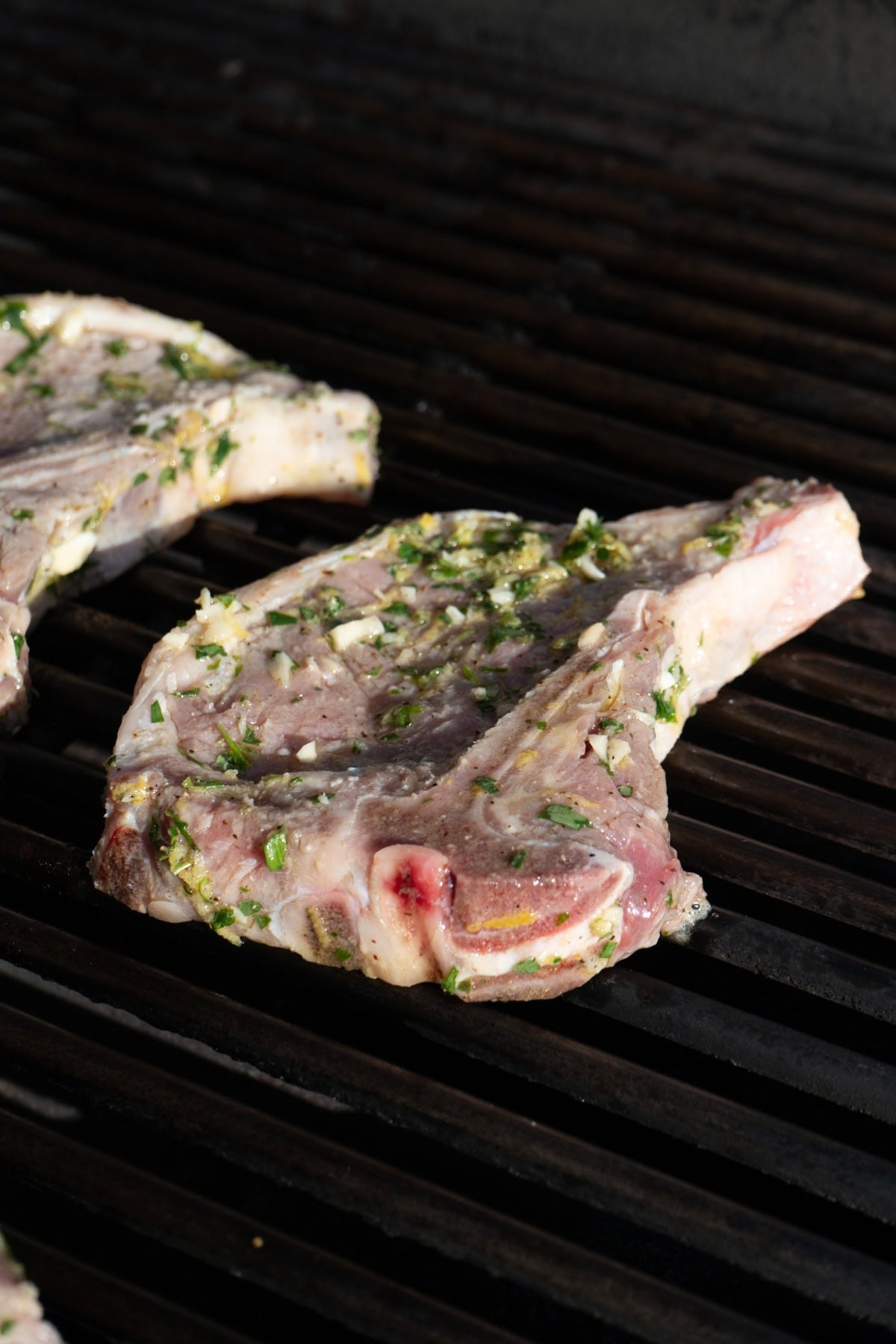 A marinated veal chop on a BBQ grill.
