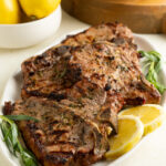 A platter of grilled veal chops with lemon and tarragon.