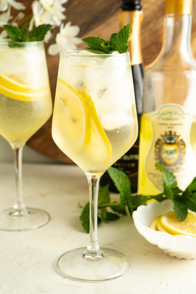 Two glasses of limoncello spritz on a table.