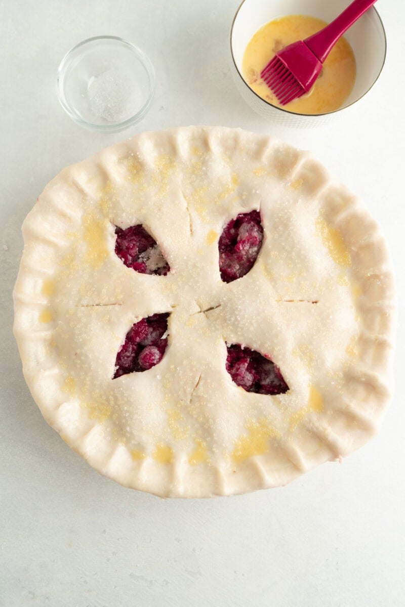 An unbaked pie sprinkled with coarse sugar.