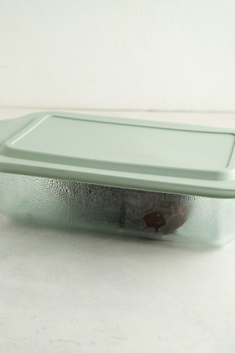 An eggplant inside of a container being steamed.