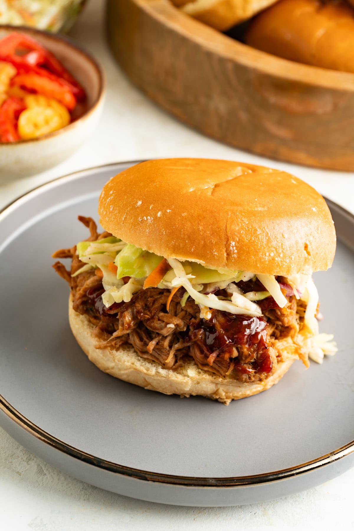A pulled pork sandwich on a plate.