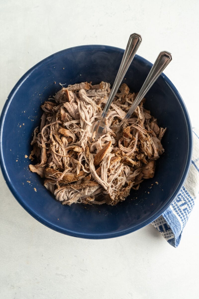 Shred the pork in a separate bowl with two forks.