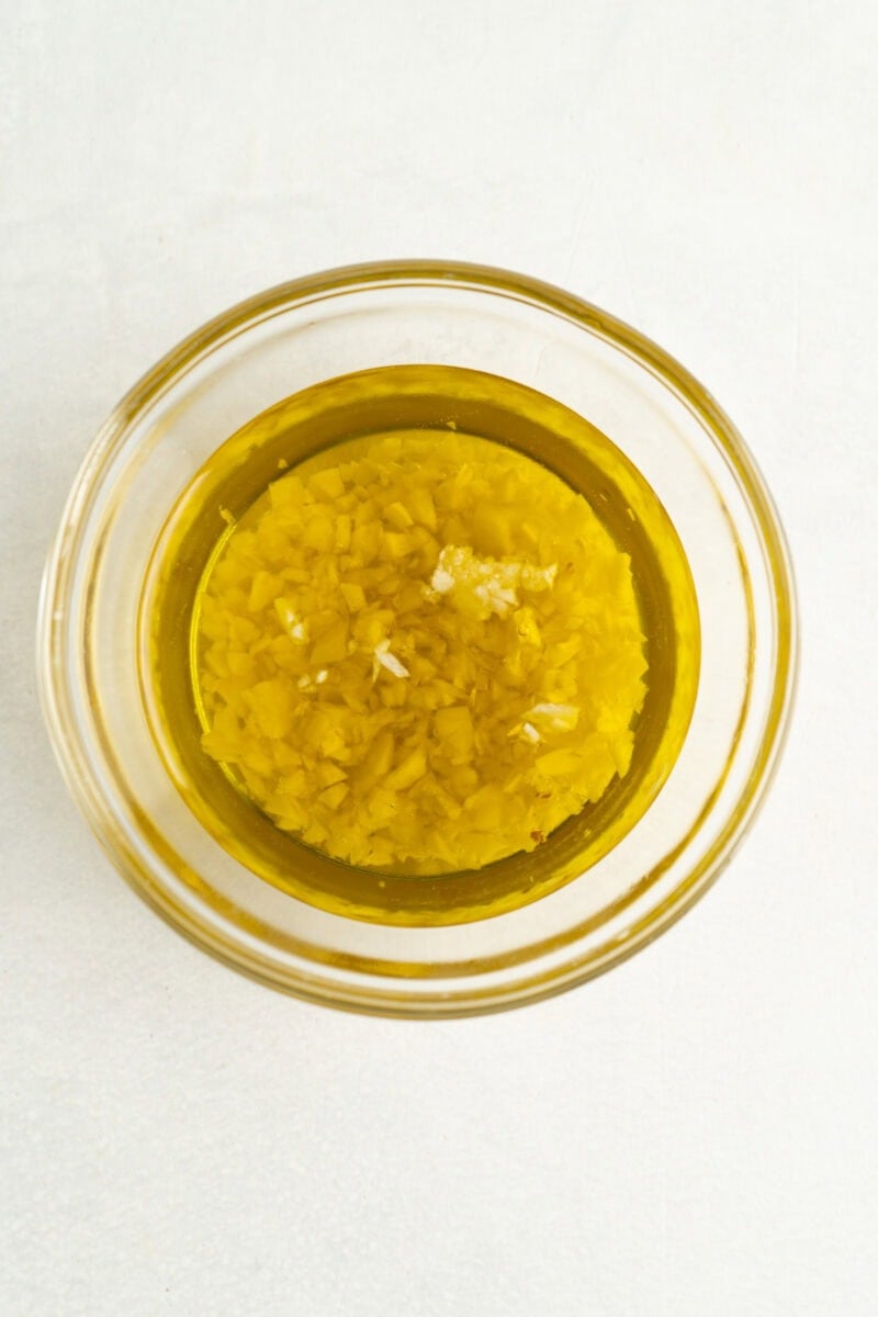 Olive oil and minced garlic in a bowl.