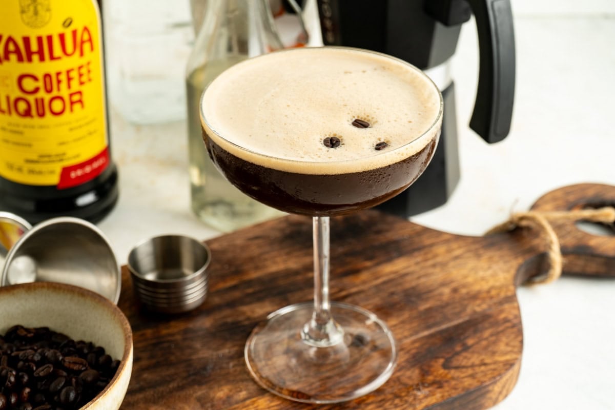 Espresso Martini on a cutting board with ingredients around.