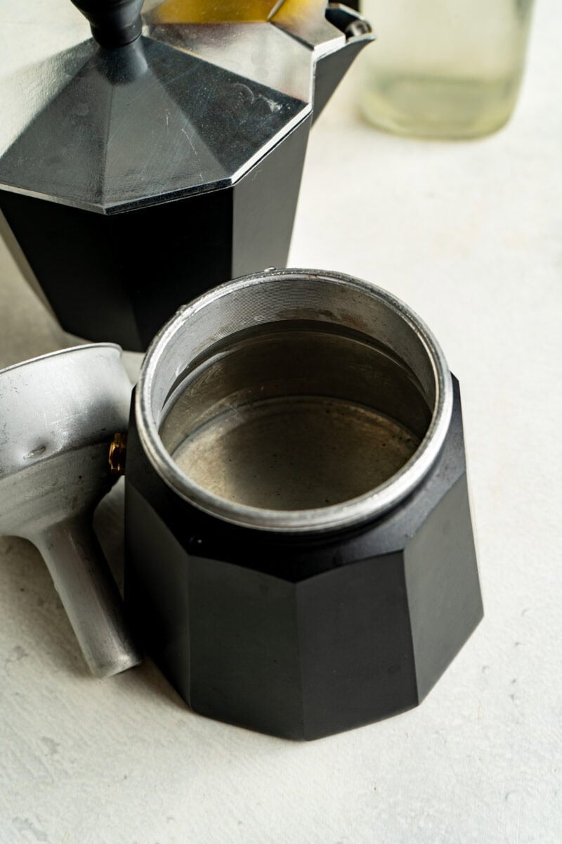 Water in the bottom of an espresso pot.