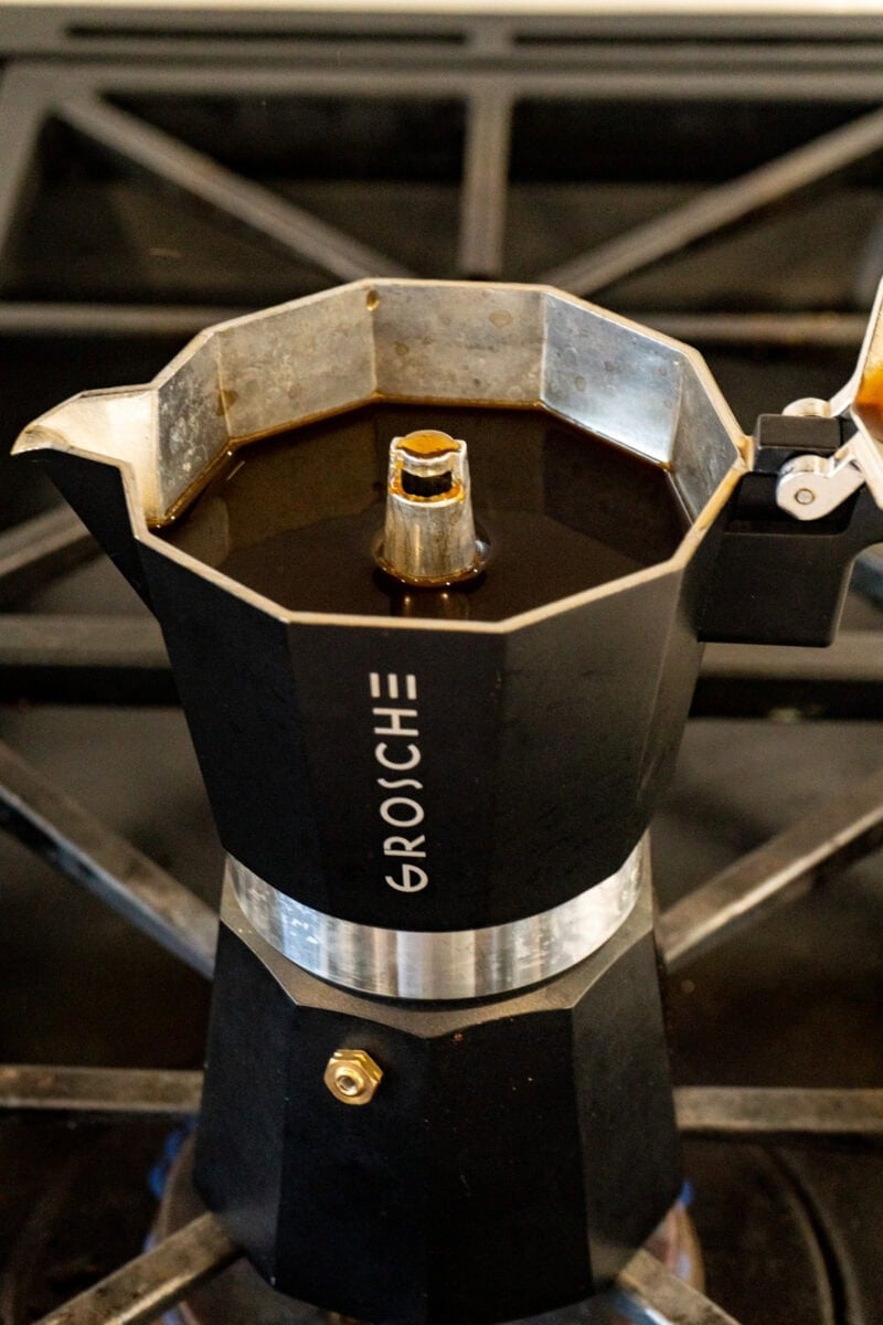 An open espresso pot showing the brewed espresso in the top of the pot.
