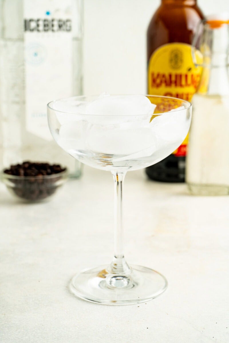 An coupe glass filled with ice.
