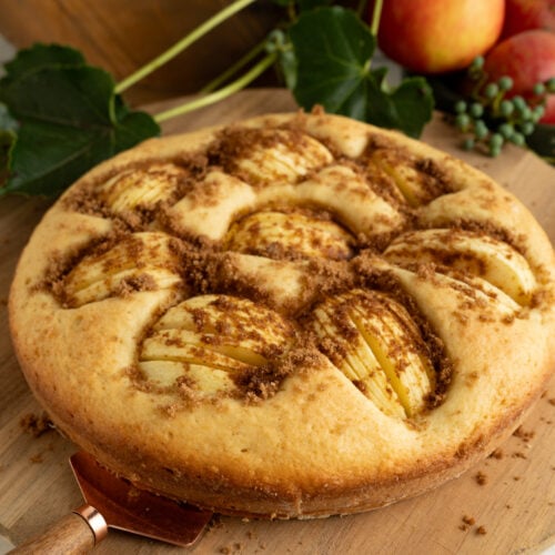 German Apple Cake on a wooden cake plate.
