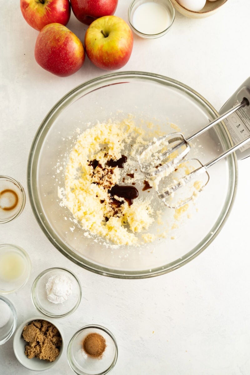 Vanilla added to a bowl of beaten butter and sugar.