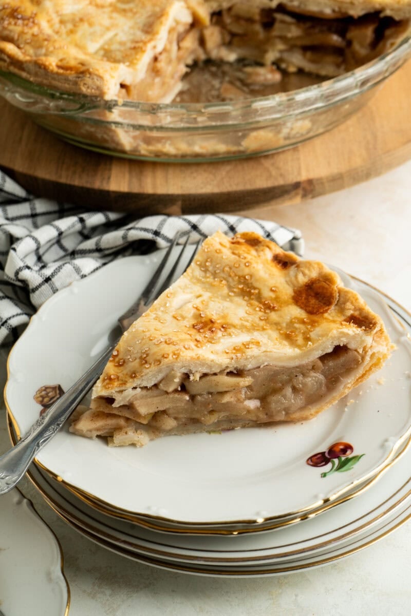 A single slice of apple pie on a plate.
